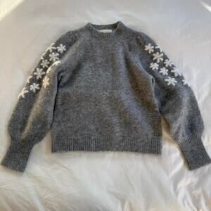 Sezane grey sweater with white flower details on the shoulder